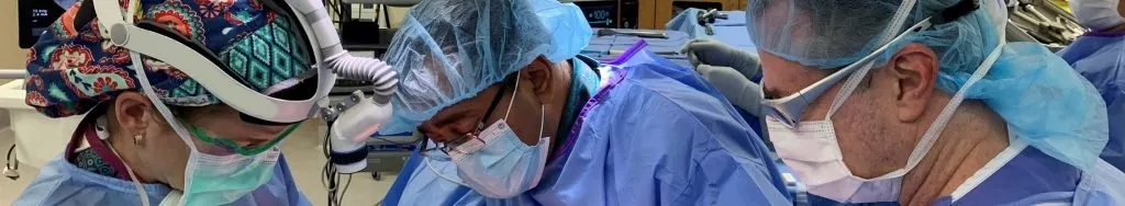 Doctors conducting surgery width="1024 height="188"
